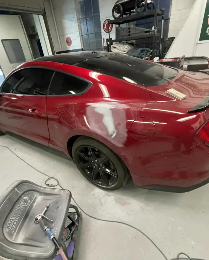 Red Ford Mustang GT in the shop for a rear quarter panel paint refinish in Lansdowne, PA