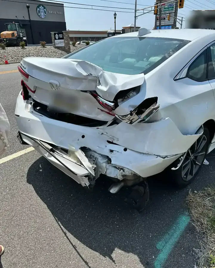 White Honda Accord with rear-end collision damage to the trunk, bumper and tail light before repair