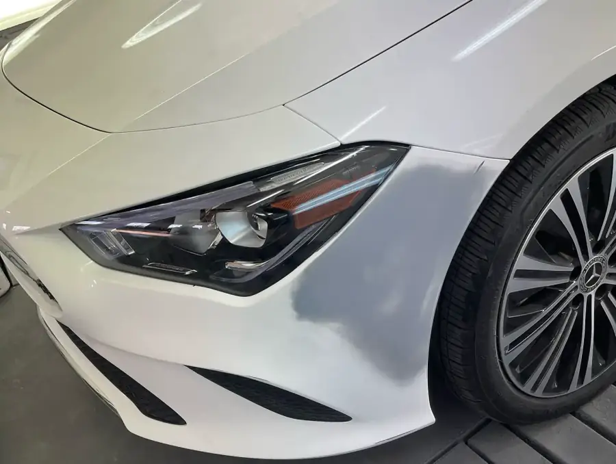 White Mercedes CLA 250 front fender and bumper sanded and prepped for paint in Lansdowne, PA