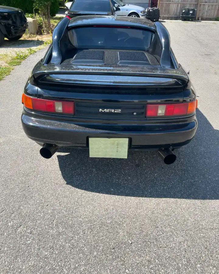 Rear view of a black right-hand-drive Toyota MR2 JDM import at AG Auto Body and Paint Experts in Lansdowne, PA